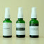 Four bottles of hair care products on a beige background
